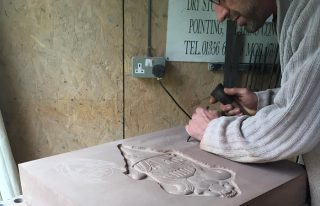 Man carving a pictish style stone